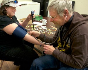 Street Nurse checks blood pressure.