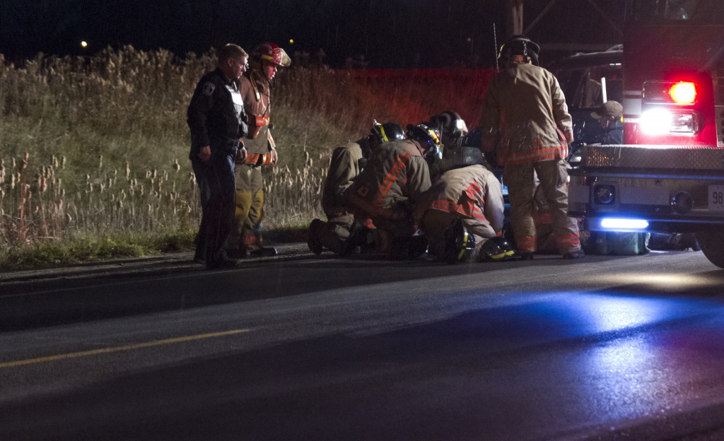 BELLEVILLE – Paramedics, police and firefighters tend to a cyclist struck twice by cars on Moria Street West on Wednesday evening. Police are seeking witnesses to the accident. Photo by Jeremy McKay, Loyalist Photojournalism