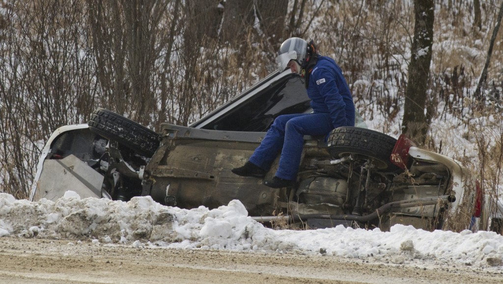 BANCROFT, Ont. [30/11/2013] Jeremy Norris climbs out of his 2000 Subaru Impreza 2.5RS while his co-driver John Merry remains trapped inside after slidding into a ditch, which flipped the car onto its side on Saturday, Nov. 30, 2013 at the 43rd annual Rally of the Tall Pines in Bancroft, Ont. The accident forced the team to withdraw from the rest of the events due to mechanical issues, ending their chances of placing. Photo by Kaitlin Abeele