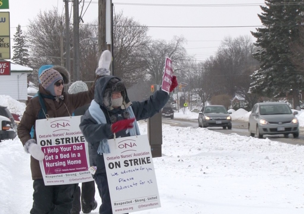Photo By: Taylor Broderick. Employees of the Community Care Access Centre protest on Bridge St. East