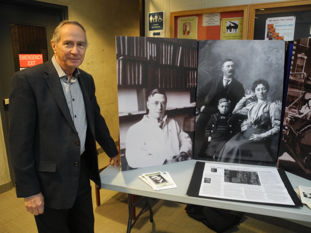 Richard Hughes, chair of the Dr. James B. Collip Recognition Committee, next to the committee's display of the famed local doctor. The display was set up at the Belleville Public Library in celebration of Dr. James B. Collip Day on Nov. 20. Photo by Joseph Quigley