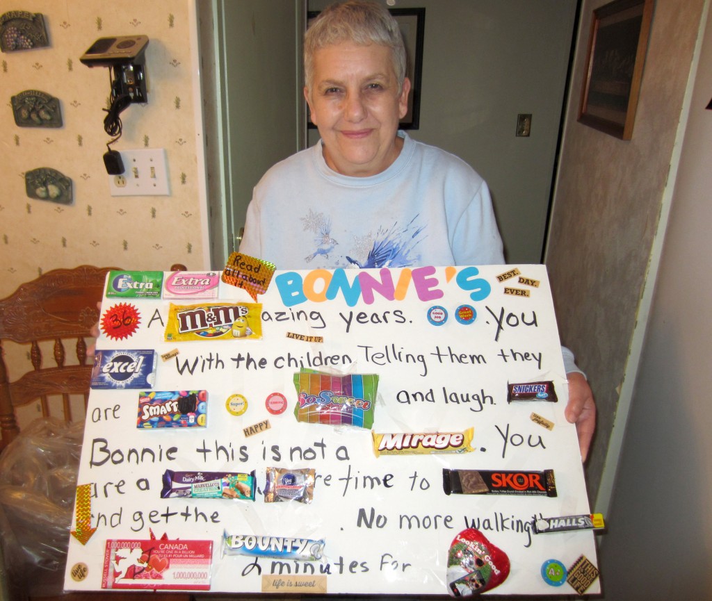 Bonnie McMillan holds a retirement gift that was made for her by another Educational Assistant