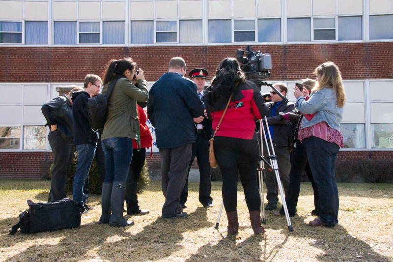 Media scrum outside Quinte Secondary School Friday morning. Photo by Ashley Clark QNet News