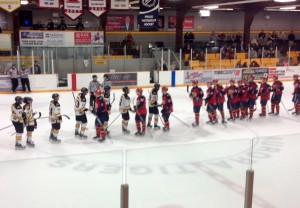The Wellington Dukes and Aurora Tigers shake hands following the deciding game 6 win by the Dukes on Monday, March 14th. Photo by Tim Durkin.