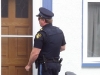 (CAMPBELLFORD 08/15/11) Police knock on doors throughout the neighbourhood where an 82-year-old woman was murdered on the weekend. Photo by Jennifer Bowman