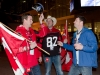 TORONTO, Ont. (25/11/2012) - Calgary Stampeders fan Mike Gusella (L) tries on Steven Anderson's Argos hat while friend Ken Brown (centre) watches during the 100th Grey Cup in Toronto, Ontario on November 25, 2012. Photo by Marta Iwanek.