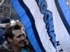 TORONTO, Ont. (25/11/12) - A man holds an Argonaut's flag during the 100th Grey Cup festival's street party on November 25th. In a sea of blue the flags stood up as a reminder of the home town's pride. Photo by Catherine Jackman.