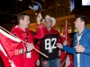 TORONTO, Ont. (25/11/2012) - Calgary Stampeders fan Mike Gusella (L) tries on Steven Anderson's Argos hat while friend Ken Brown (centre) watches during the 100th Grey Cup in Toronto, Ontario on November 25, 2012. Photo by Marta Iwanek.