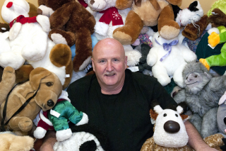 BELLEVILLE, Ont. (23/11/2011) - John Stephenson, retired firefighter and chairman of the Belleville Firefighters' annual Toy Drive nestles himself into the donated stuffed toys on Wednesday, Nov. 23, 2011. The drive collects toys for approximately 1,300 children in the local area. Donation dropoffs are at north end of the Sidney Street Avaya complex, Bay View Mall by the LCBO, Quinte Mall outside Toys 'R' Us and any city fire hall. Photo by Jessica Corriveau