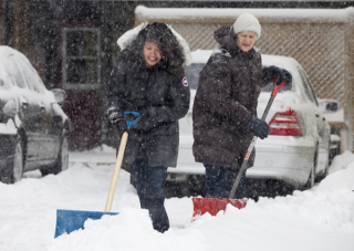 BELLEVILLE, ONT. (13/01/12) â Leticia Siasat gets help from her landlord Helga Hasleuer during the first real snow fall in Belleville this winter. Siasat said her car was practically buried but she didn't mind the snow. Weather reports say there was about 10-15cm by Friday afternoon but more snow continues to fall. (Photo by Kristen Haveman)