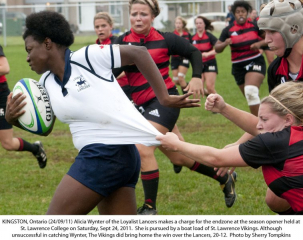 KINGSTON, Ontario (24/09/11) Alicia Wynter of the Loyalist Lancers makes a charge for the endzone at the season opener held at St. Lawrence College on Saturday, Sept 24, 2011.  She is pursued by a boat load of St. Lawrence Vikings.  Although unsuccessful in catching Wynter, The Vikings did bring home the win over the Lancers, 20-12.  Photo by Sherry Tompkins