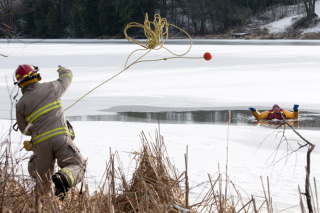 NAPANEE, Ont. (28/01/12) â A member of the Fire Serviceâs Specialized Rescue Team throws a rope to a team member during their annual ice and water training Saturday morning on the Napanee River. Members of the 12 person team went through several drills for the first time this year in order to train four new members and go over past training. The practice seemed increasingly important as just last week, two snowmobilers were rescued from the Bay of Quinte, about a week after the Sophiasburgh ice rescue team did their own training on the water. Photo by Melissa Murray.