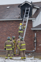 TRENTON, Ont. (02/01/2012): A fire at home in Trenton on Wednesday Feb 1 on 79 Ontario Street. Witness said black smoke started pouring out of the attic window and was then followed by huge flames. The owner was home but made it out of house after one of the co-workers, from Capelli Salon, which is adjacent to the home, banged on the door. Photo by Tristan Kong.