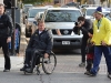 Rick Hansen wheels his way into Market Square surrounded by medal bearer Harold Cliff Andrews, fans and media.
Photo by Taylor Renkema