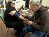 BELLEVILLE, Ont. (16/02/12)â Doug Roy checks Nicole Taylors blood pressure after she confronted Roy about frequent nose bleeds. Photo by Brynn Campbell.