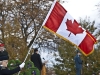 A woman marches with the Canadian flag errect during the Remembrance Day ceremony in Trenton, Ontarion. Photo by Ashliegh Gehl.