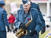 A saxophone player with instrument and stand in hand walks away from the cenotaph in Trenton, Ontario, on Friday after playing music for the Remembrance Day ceremony. Photo by Ashliegh Gehl.