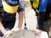 Wearing his official derby hat Issac Waller-Dupont and his friend Jordan Millard check on the fish they caught in the bay. Photo: Gail Paquette