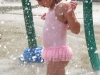 TRENTON, Ont. (21/07/11) Mayan Forsey-MacKinnon, 3, from Bayside, stands under a sprinkler at Trenton's Centennial Park splash pad. She came with her aunt to beat the heat. Photo by Renee Rodgers.