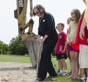 School board trustee Bonnie Danes puts the shovel into the ground on the spot where the new school in Stirling will sit at the ground-breaking ceremony, June 28. Jasper Construction Corporation will begin work immediately and said the school will open September 2013. Photo by Gail Paquette