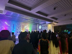 A Student was singing and the audience is enjoying it. 