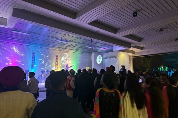 A Student was singing and the audience is enjoying it.